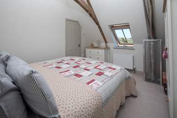 Bedroom 2 has an en suite shower room and a safety cage protects the flue that comes up from the wood-burner below.