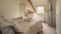 Bedroom 2 has an en suite shower room and a safety cage protects the flue that comes up from the wood-burner below.