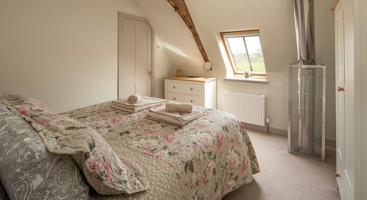 Bedroom 2 has an en suite shower room and a safety cage protects the flue that comes up from the wood-burner below.