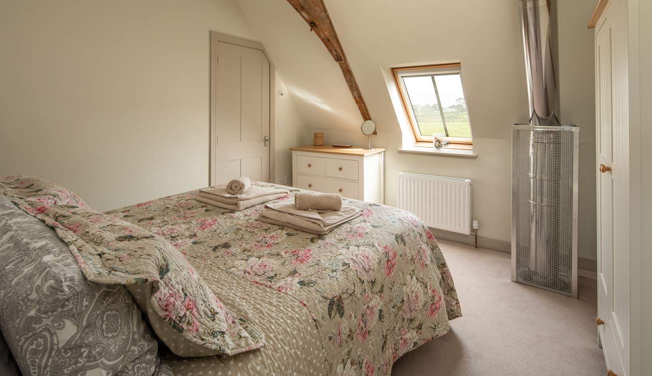 Bedroom 2 has an en suite shower room and a safety cage protects the flue that comes up from the wood-burner below.