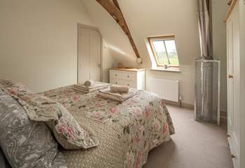 Bedroom 2 has an en suite shower room and a safety cage protects the flue that comes up from the wood-burner below.