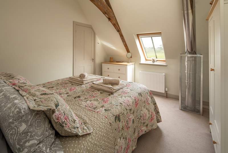 Bedroom 2 has an en suite shower room and a safety cage protects the flue that comes up from the wood-burner below.