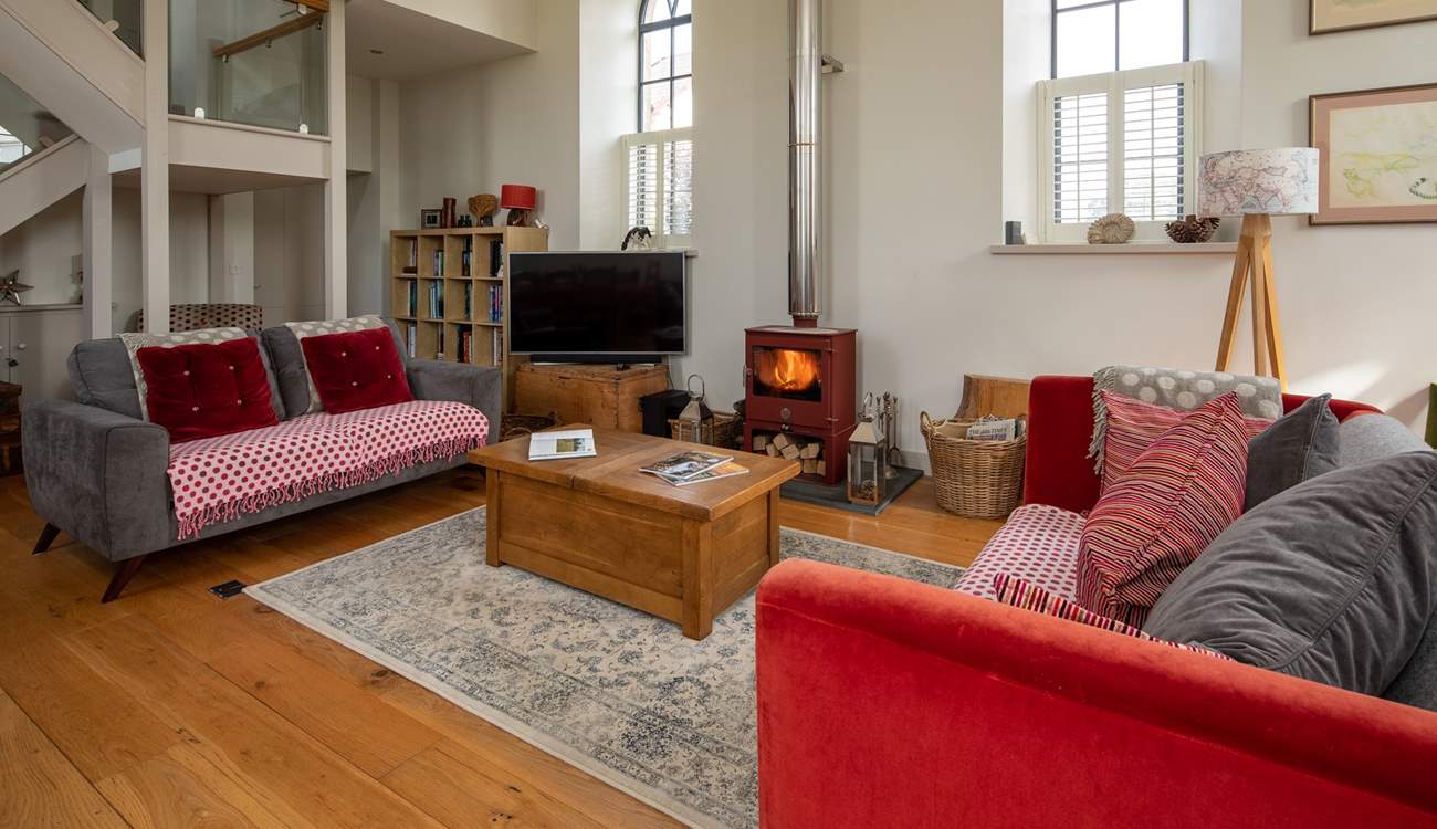 This wonderful open plan sitting-room has a cosy wood-burner for cooler evenings.