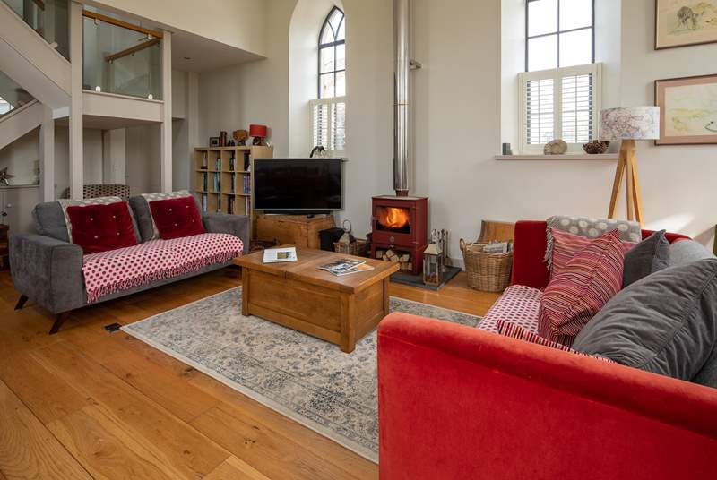 This wonderful open plan sitting-room has a cosy wood-burner for cooler evenings.