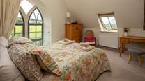 The master bedroom has this beautiful feature window, protected by a glass safety screen.