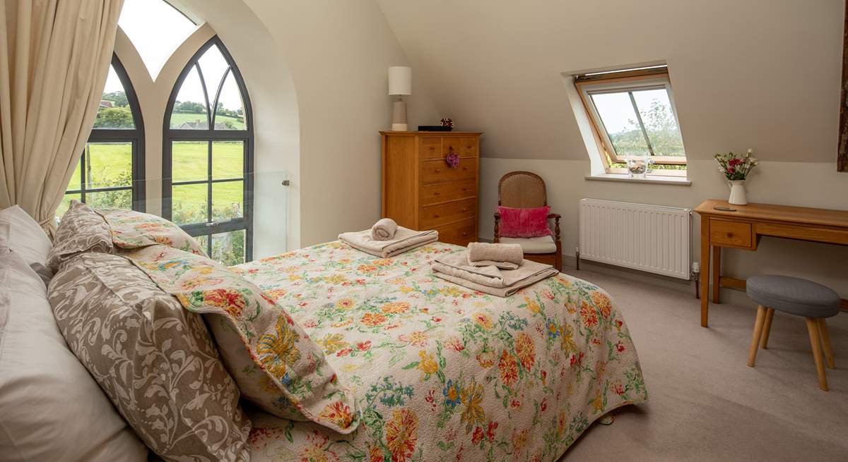 The master bedroom has this beautiful feature window, protected by a glass safety screen.