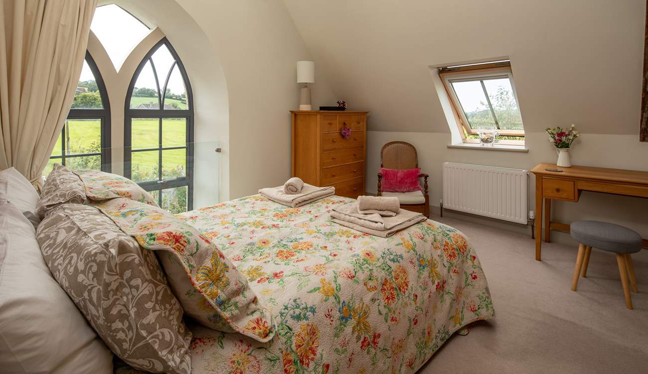 The master bedroom has this beautiful feature window, protected by a glass safety screen.