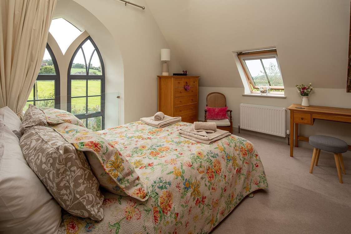The master bedroom has this beautiful feature window, protected by a glass safety screen.