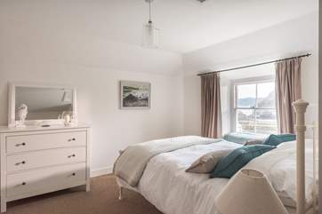 Bedroom 1 looks out over the harbour and coastline.