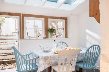 The glazed roof in the dining-area lets light flood in.