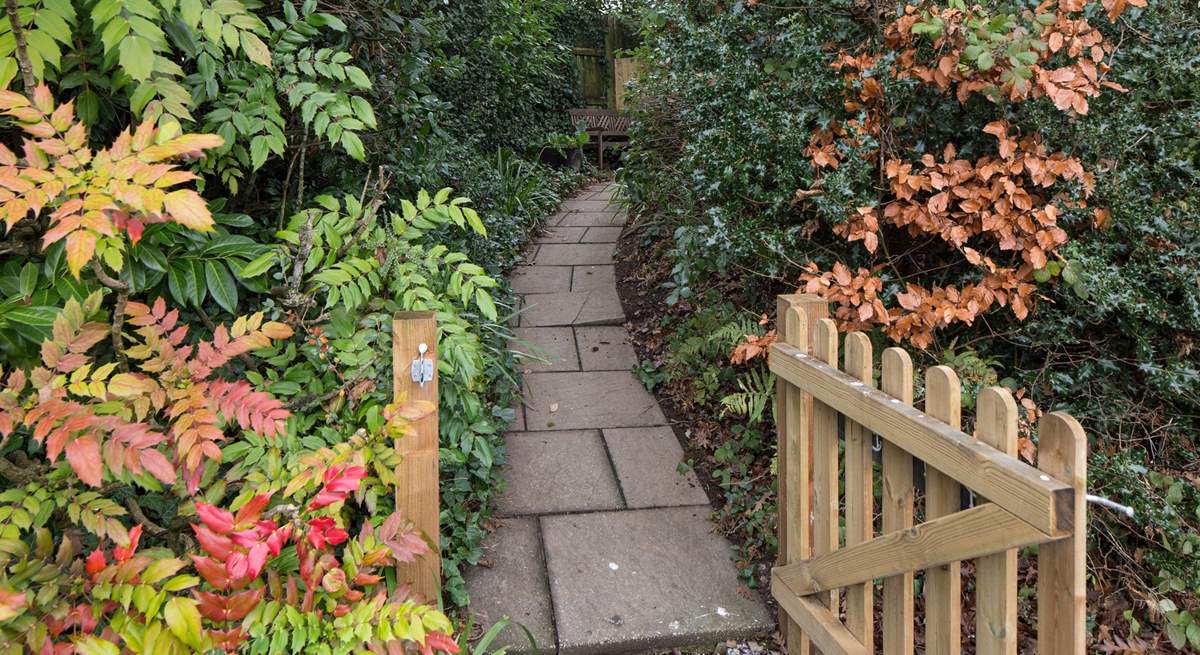 Once parked up, follow this pretty pathway to access your dream holiday cottage.