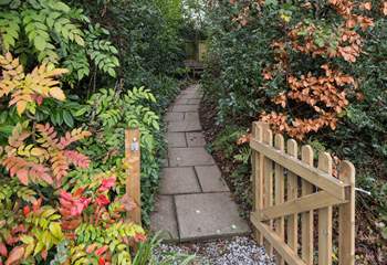 Once parked up, follow this pretty pathway to access your dream holiday cottage.