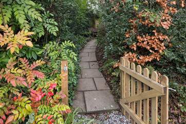 Once parked up, follow this pretty pathway to access your dream holiday cottage.