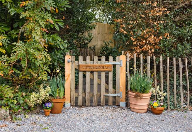 Once parked up, follow this pretty pathway to access your dream holiday cottage.