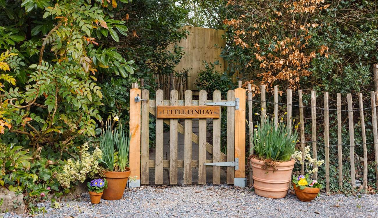 Once parked up, follow this pretty pathway to access your dream holiday cottage.