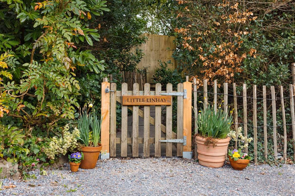 Once parked up, follow this pretty pathway to access your dream holiday cottage.
