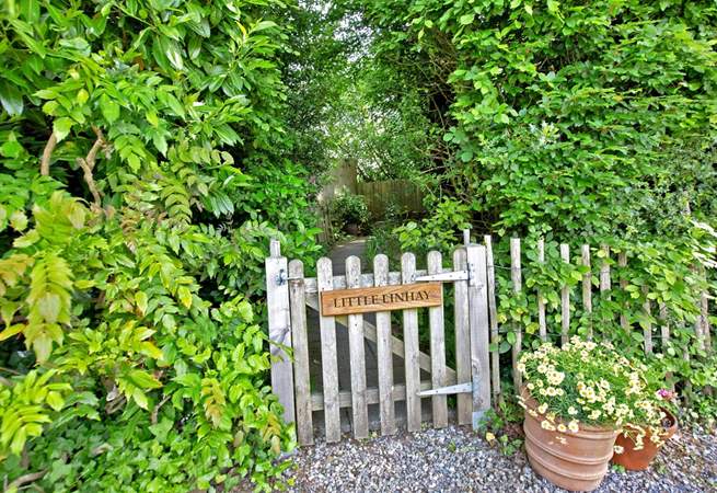 Once parked up, follow this pretty pathway to access your dream holiday cottage.