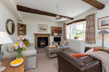 This is the gorgeous sitting-room with its wood-burning stove and wonderful views across the top of the village to the moorland beyond.