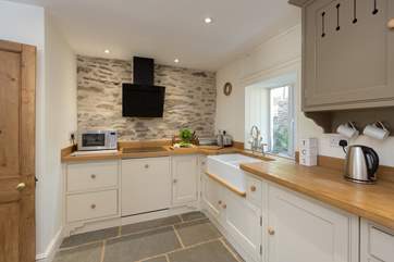 There is a double Belfast sink, a dishwasher and a washing machine through the door on the left.