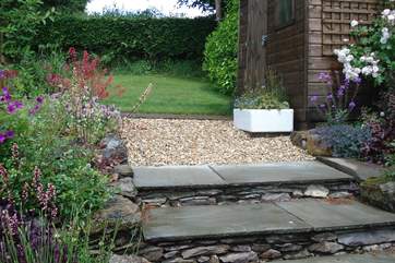 The back garden has a lovely area of lawn as well as the really beautiful flower borders.