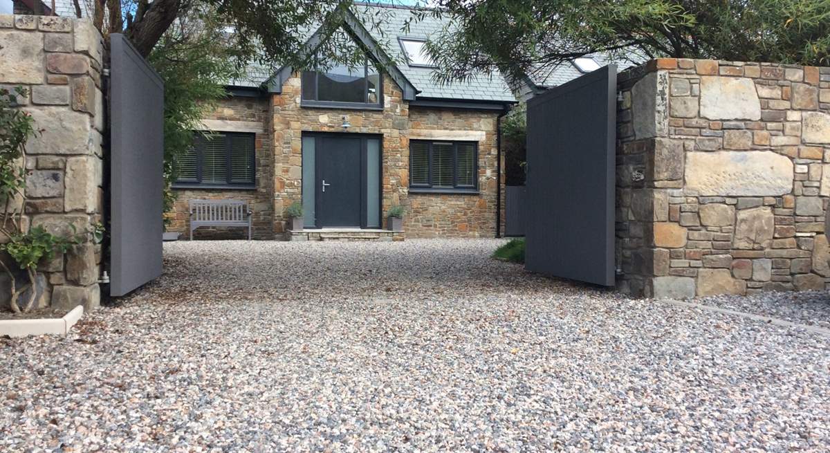 The Willows is a lovely bespoke detached house - an absolute labour of love, with front and rear outside space to enjoy. There is a lawn just inside the gates to the right.