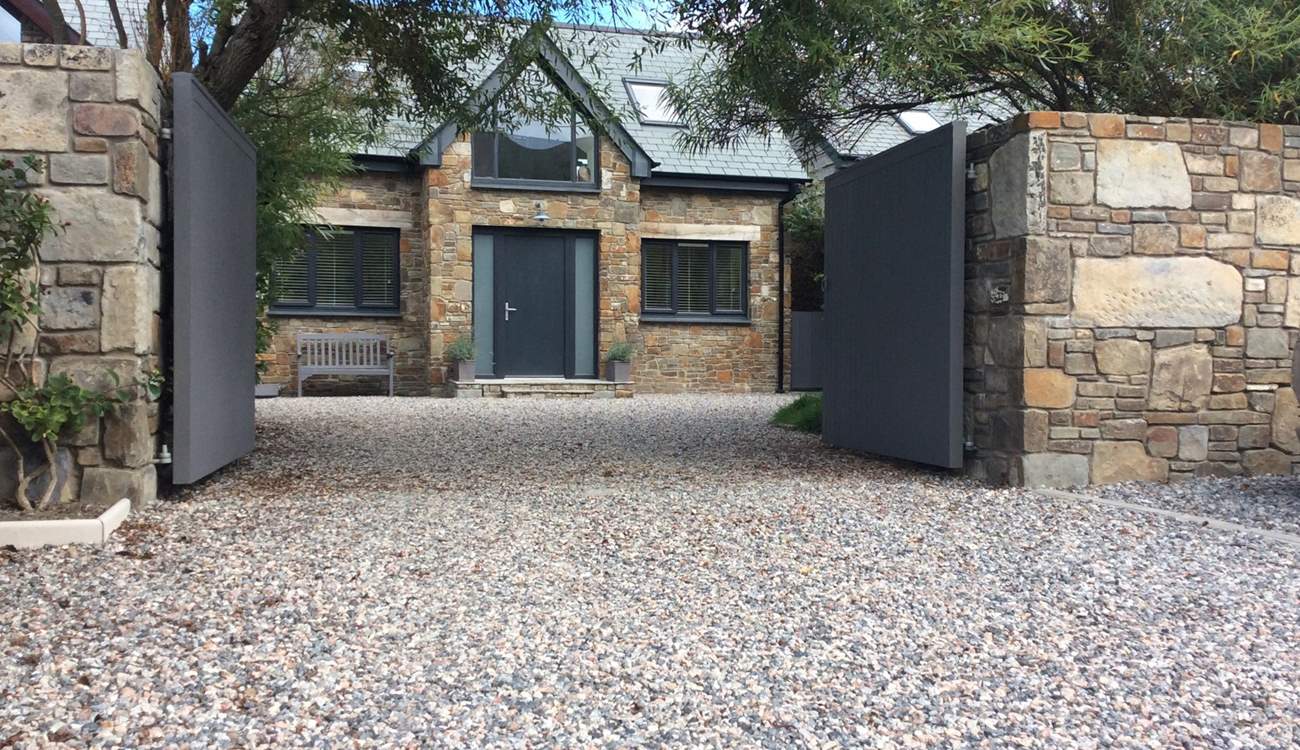 The Willows is a lovely bespoke detached house - an absolute labour of love, with front and rear outside space to enjoy. There is a lawn just inside the gates to the right.