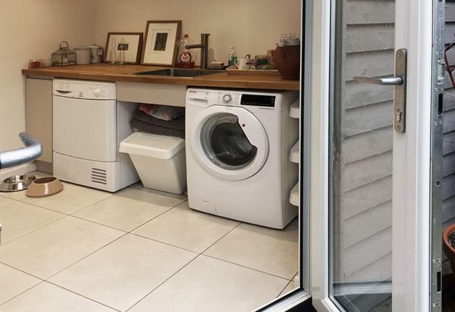 A well thought out utility space offering access to separate laundry facilities, 2nd fridge freezer, wet suits, towels and somewhere to tend to your dog. 