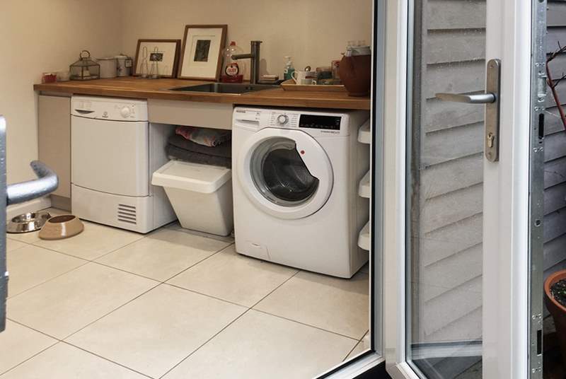 A well thought out utility space offering access to separate laundry facilities, 2nd fridge freezer, wet suits, towels and somewhere to tend to your dog. 