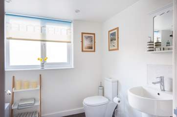 The family bathroom is spacious and has a bath and an electric shower.