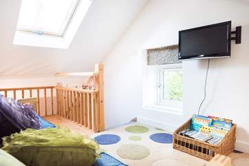 A flight of stairs lead up to the snug where there is a TV, books and lots of games for the younger ones.