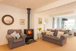 The cosy living-room has ample seating for everyone to relax together.