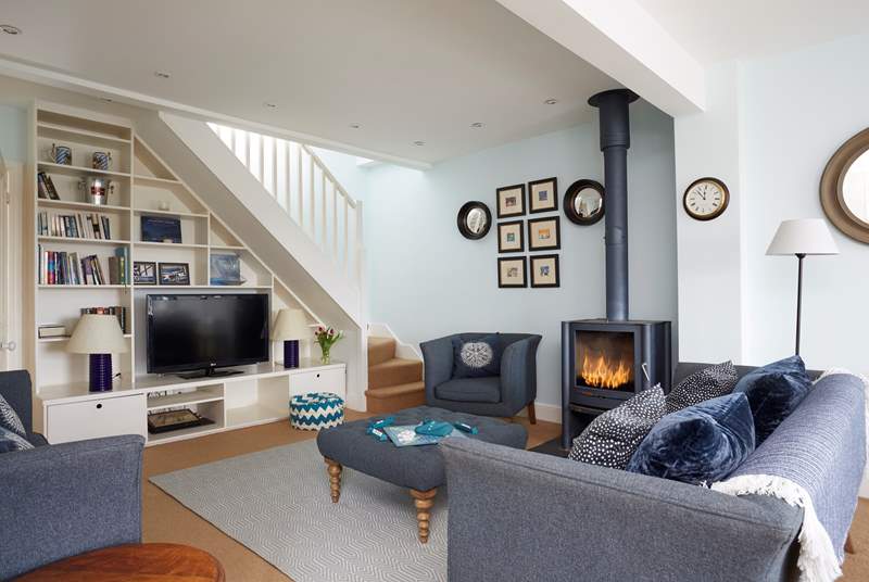 The cosy living-room has ample seating for everyone to relax together.