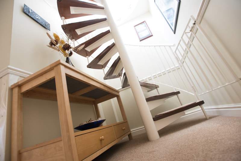 The spiral staircase leads up to the sun-room and roof terrace.