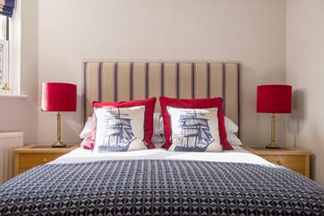 The master bedroom has a double bed with nautical influences.