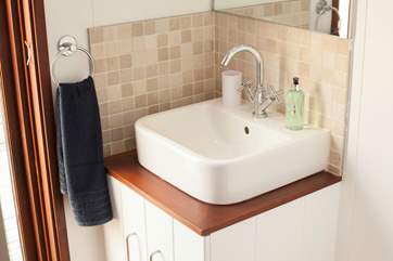The master bedroom is home to a modern en suite, with walk-in shower.
