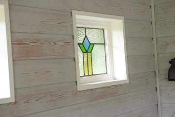These upcycled windows bring a beautiful light into the cabin.
