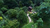 Meander along the path to find your woodland cabin at the top of a pretty orchard. 
