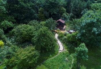 Meander along the path to find your woodland cabin at the top of a pretty orchard. 