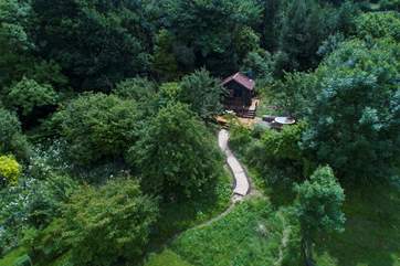 An aerial view that shows the cabin at the top of the orchard.
