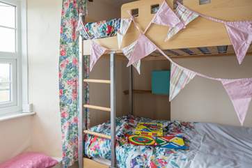 This children's bunk bedroom is cosy and exciting for the children in your family.
