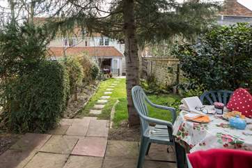 Have a cream tea at the top of the garden shaded by the tree.