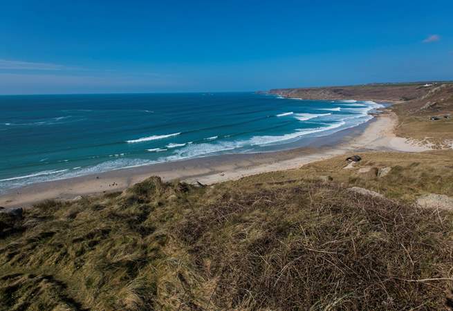 No Place is set above the white sand and blue seas at Sennen Cove (not the view from the property).