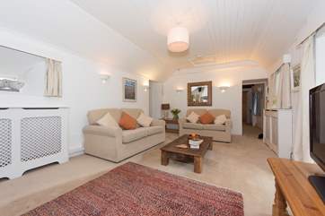 The two bedrooms are off of the sitting-room. Bedroom 1 to the left and bedroom 2 with twin beds to the right.