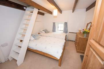 Bedroom 2 with twin beds and open-tread stairs to the snug.