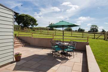 There is a panoramic view across the fields for miles from the patio and enclosed garden-area above it.