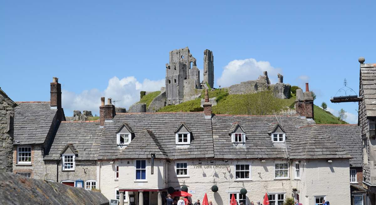 Corfe Castle stands imposingly above the village of Corfe. The Swanage steam railway runs along the side of the village and stops at the little station there.