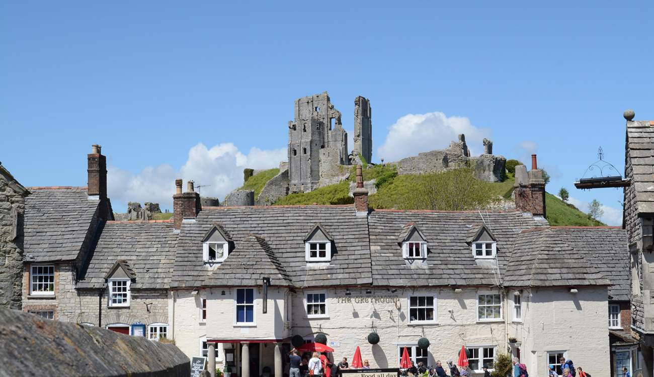 Corfe Castle stands imposingly above the village of Corfe. The Swanage steam railway runs along the side of the village and stops at the little station there.