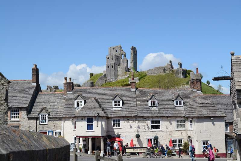 Corfe Castle stands imposingly above the village of Corfe. The Swanage steam railway runs along the side of the village and stops at the little station there.