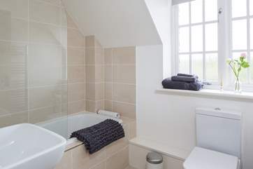 The modern family bathroom is at the front of the cottage.