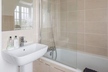 The family bathroom has a shower over the bath